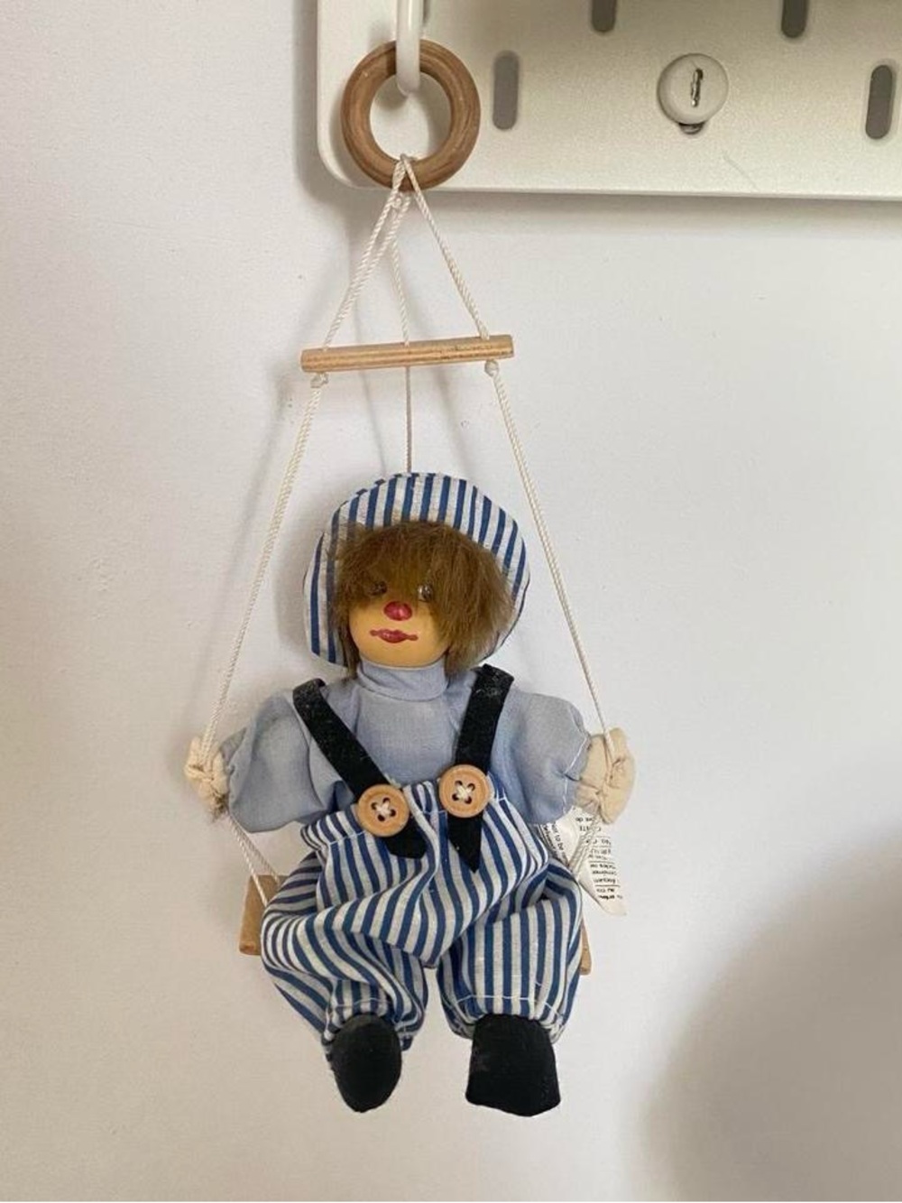 Wooden hand painted blue clown on a swing